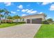 Charming home with a 2-car garage, beautiful landscaping and a brick driveway at 703 Monte Cristo Blvd, Tierra Verde, FL 33715