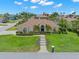 A stunning home with beautiful landscaping in the front yard and a tiled roof at 703 Monte Cristo Blvd, Tierra Verde, FL 33715