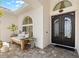 Elegant home front entrance featuring a decorative wrought iron door and an inviting seating area with stylish decor at 703 Monte Cristo Blvd, Tierra Verde, FL 33715
