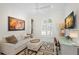 Bright home office with modern decor, white ceiling fan, arched window with plantation shutters, and neutral colored rug at 703 Monte Cristo Blvd, Tierra Verde, FL 33715