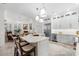 Modern kitchen features a large island with seating, stainless steel appliances and wine refrigerator at 703 Monte Cristo Blvd, Tierra Verde, FL 33715