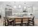 Modern kitchen features a large island with seating, stainless steel appliances and custom lighting at 703 Monte Cristo Blvd, Tierra Verde, FL 33715