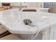 Close up of the kitchen island featuring a stone countertop and neutral colored seating at 703 Monte Cristo Blvd, Tierra Verde, FL 33715