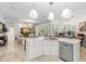Open kitchen featuring a large island, stainless steel appliances and seamless flow to the living room at 703 Monte Cristo Blvd, Tierra Verde, FL 33715