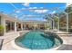Gorgeous screened-in pool with a spa and inviting lounge areas, perfect for relaxation and entertainment at 703 Monte Cristo Blvd, Tierra Verde, FL 33715