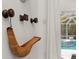 Unique wall decor featuring vintage wooden pulleys and a woven basket detail; pool visible in the background at 703 Monte Cristo Blvd, Tierra Verde, FL 33715