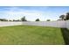 Spacious backyard with lush green grass, perfect for outdoor activities, and a white fence at 7170 Samuel Ivy Dr, Tampa, FL 33619