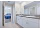 Bathroom featuring granite countertops, double vanity, and Primary bedroom access at 7170 Samuel Ivy Dr, Tampa, FL 33619