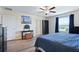 Cozy bedroom boasts Starry Night painting, ceiling fan and wood floors at 7170 Samuel Ivy Dr, Tampa, FL 33619