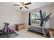 Bedroom featuring workout equipment, neutral walls and lots of natural light at 7170 Samuel Ivy Dr, Tampa, FL 33619