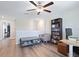 Bedroom featuring wood floors, a ceiling fan, and a bookshelf at 7170 Samuel Ivy Dr, Tampa, FL 33619