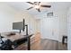 Bedroom featuring a wood floors, ceiling fan, closet and a desk at 7170 Samuel Ivy Dr, Tampa, FL 33619