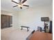 Bonus room with tile flooring, exercise equipment and a ceiling fan at 7170 Samuel Ivy Dr, Tampa, FL 33619