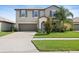 Inviting two-story home featuring a spacious driveway and a well-maintained lawn in a Gathering-friendly neighborhood at 7170 Samuel Ivy Dr, Tampa, FL 33619