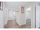 Well-lit hallway with wood floors leading to an open bedroom at 7170 Samuel Ivy Dr, Tampa, FL 33619