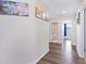 Hallway boasts wood floors, artwork and bathroom and bedroom access at 7170 Samuel Ivy Dr, Tampa, FL 33619