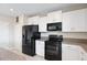 Kitchen features white cabinets, granite countertops, and stainless steel appliances at 7170 Samuel Ivy Dr, Tampa, FL 33619