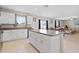 Open concept kitchen features island with bar and granite countertops at 7170 Samuel Ivy Dr, Tampa, FL 33619