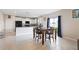 Bright eat-in kitchen featuring tile floors, white cabinets, and black appliances at 7170 Samuel Ivy Dr, Tampa, FL 33619