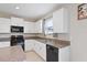 Well-lit kitchen has white cabinets, granite countertops, and stainless steel appliances at 7170 Samuel Ivy Dr, Tampa, FL 33619