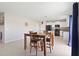 Open concept dining and kitchen area with natural light and tile flooring at 7170 Samuel Ivy Dr, Tampa, FL 33619