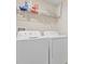 Bright laundry room featuring a white washer and dryer at 7170 Samuel Ivy Dr, Tampa, FL 33619