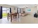 Bright living room with tile floors, slider to backyard, and modern furnishings at 7170 Samuel Ivy Dr, Tampa, FL 33619