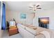 Living room with tile flooring, a large sectional sofa, TV and neutral walls at 7170 Samuel Ivy Dr, Tampa, FL 33619
