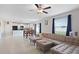 Open-concept living room with tile flooring seamlessly connecting to the dining area at 7170 Samuel Ivy Dr, Tampa, FL 33619