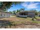 Backyard with screened patio and storage building in yard at 7222 N Amos Ave, Tampa, FL 33614