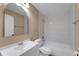 Bright bathroom featuring a modern vanity, mirror, and a combined toilet, tub, and shower at 7222 N Amos Ave, Tampa, FL 33614