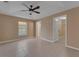 Bedroom featuring tile floors, neutral paint, and a window overlooking the backyard at 7222 N Amos Ave, Tampa, FL 33614