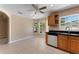 Bright eat-in kitchen area with tiled flooring, a ceiling fan and generous sunlight through large windows at 7222 N Amos Ave, Tampa, FL 33614