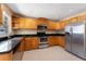 Well-lit kitchen boasts stainless steel appliances, granite countertops, and ample wooden cabinetry at 7222 N Amos Ave, Tampa, FL 33614