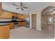 Open concept kitchen features stainless steel appliances, wooden cabinets, and easy access to other rooms at 7222 N Amos Ave, Tampa, FL 33614