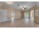 Spacious living room with neutral tones, tile flooring, and sliding glass doors to the outside at 7222 N Amos Ave, Tampa, FL 33614