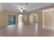 Open-concept living area with tile flooring, arched doorways, and natural light from the outside patio at 7222 N Amos Ave, Tampa, FL 33614