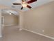 Spacious living room with tile floors, neutral walls, modern ceiling fan, and an arched entryway at 7222 N Amos Ave, Tampa, FL 33614