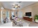 Bright living room with tile floors, ceiling fan, modern furniture, and a decorative rug at 7222 N Amos Ave, Tampa, FL 33614