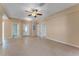 Open living room with tiled floors, multiple doorways, and neutral paint for easy customization at 7222 N Amos Ave, Tampa, FL 33614