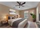 Stylishly furnished main bedroom featuring neutral color scheme, modern décor, and ample natural light at 7222 N Amos Ave, Tampa, FL 33614