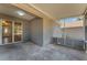 Enclosed patio with gray concrete floors and sliding glass door to the interior of the home at 7222 N Amos Ave, Tampa, FL 33614