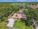 Aerial view of home with lush greenery, well-manicured lawn, and a long driveway at 7507 Beasley Rd, Tampa, FL 33615