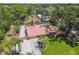 Aerial view of home with lush greenery, well-manicured lawn, and a long driveway at 7507 Beasley Rd, Tampa, FL 33615