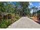 Long driveway beside backyard with unique landscaping and seating area at 7507 Beasley Rd, Tampa, FL 33615