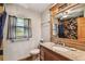 Bathroom featuring a single sink, granite countertops, and window at 7507 Beasley Rd, Tampa, FL 33615