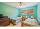 Bedroom featuring two twin beds, a ceiling fan, and a window at 7507 Beasley Rd, Tampa, FL 33615