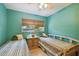 Bedroom featuring two twin beds, a ceiling fan, and a window at 7507 Beasley Rd, Tampa, FL 33615