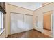 Bright bedroom featuring hardwood floors and double closets, offering storage and natural light at 7507 Beasley Rd, Tampa, FL 33615