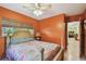 Bedroom featuring orange walls, ceiling fan, and window at 7507 Beasley Rd, Tampa, FL 33615